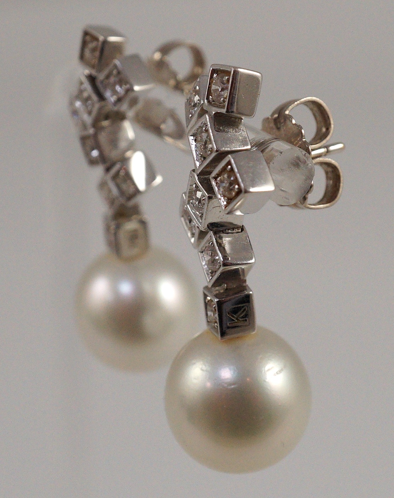 A modern pair of 18ct white gold, single stone South Sea pearl and eight stone diamond cluster set drop earrings, by Kailis